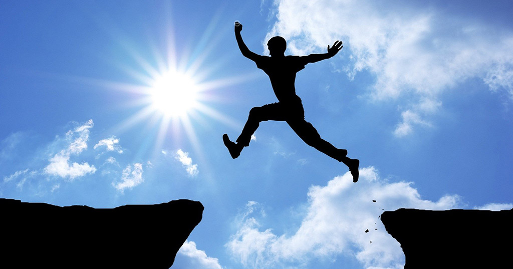 man jumping from cliff