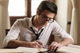 man writing books