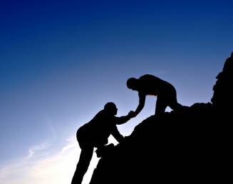 man helping his friend climb